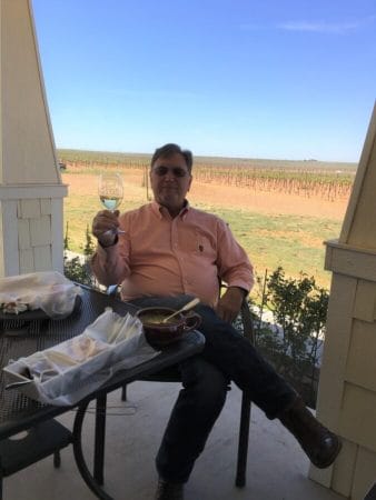 Bill Day with his Buena Suerte Vineyards in the background