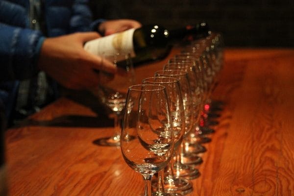 wine pouring into multiple glasses