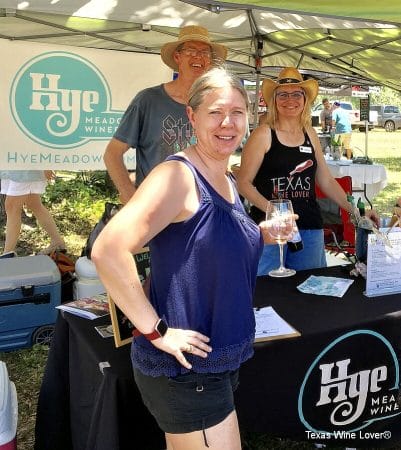 Shelly and Laurie Ware serving wine to a festival attendee at the Hye Meadow Winery booth