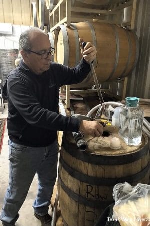 Mark Rogers getting wine from the barrel